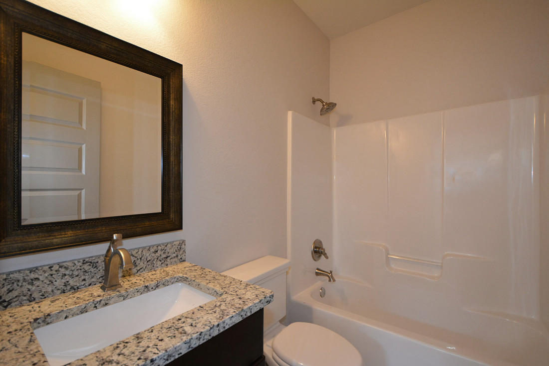 50 Mobile Street Miramar Beach, FL 32550 - Photo 23 of 28 a bathroom with a granite countertop sink toilet and mirror