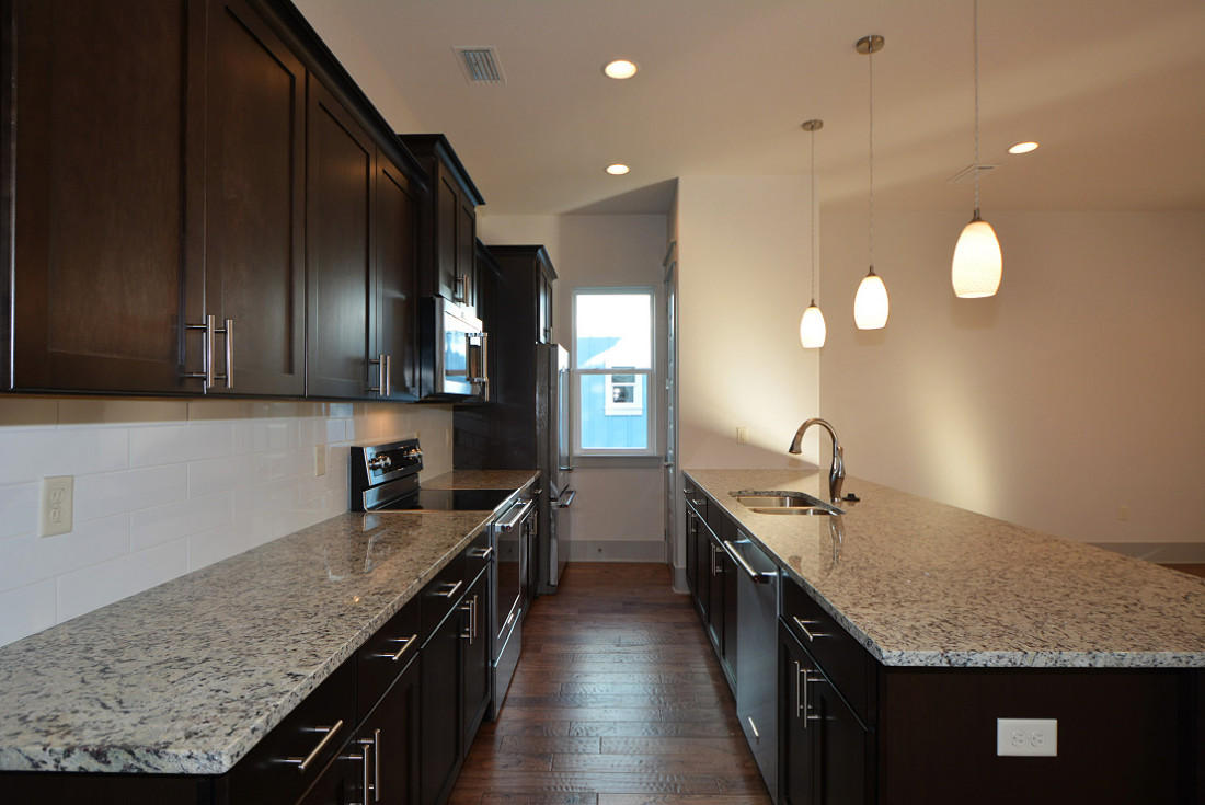 50 Mobile Street Miramar Beach, FL 32550 - Photo 7 of 28 a kitchen with stainless steel appliances granite countertop sink stove and cabinets
