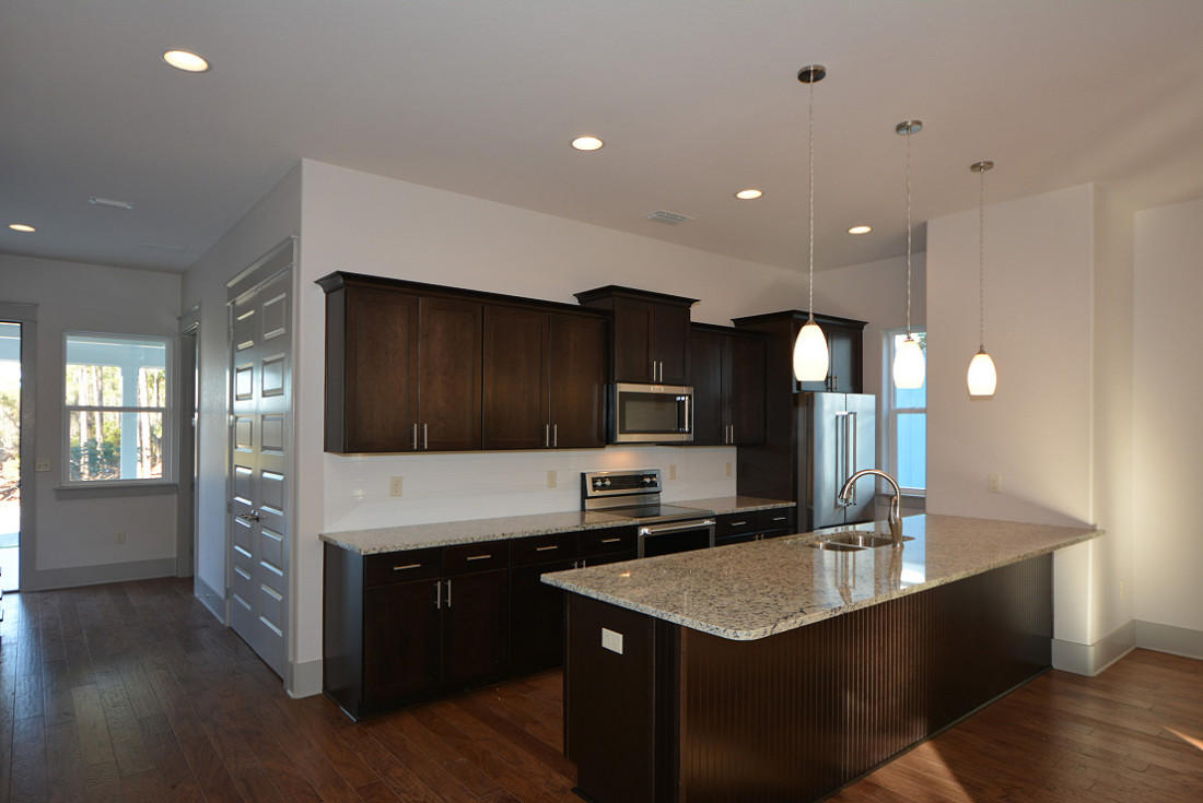 50 Mobile Street Miramar Beach, FL 32550 - Photo 8 of 28 a kitchen with kitchen island granite countertop a stove and a sink with wooden floor
