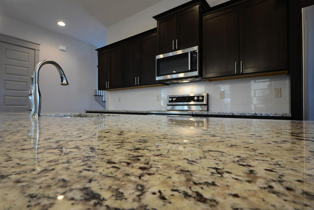 50 Mobile Street Miramar Beach, FL 32550 - Photo 10 of 28 a kitchen with granite countertop a toilet a sink and a microwave