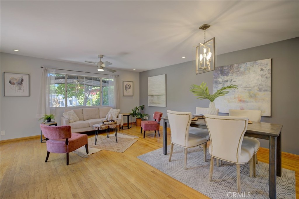 7001 Lindley Avenue Reseda, CA 91335 - Photo 13 of 45 a living room with furniture a chandelier and a window
