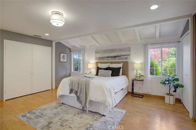 a bedroom with a bed and a potted plant