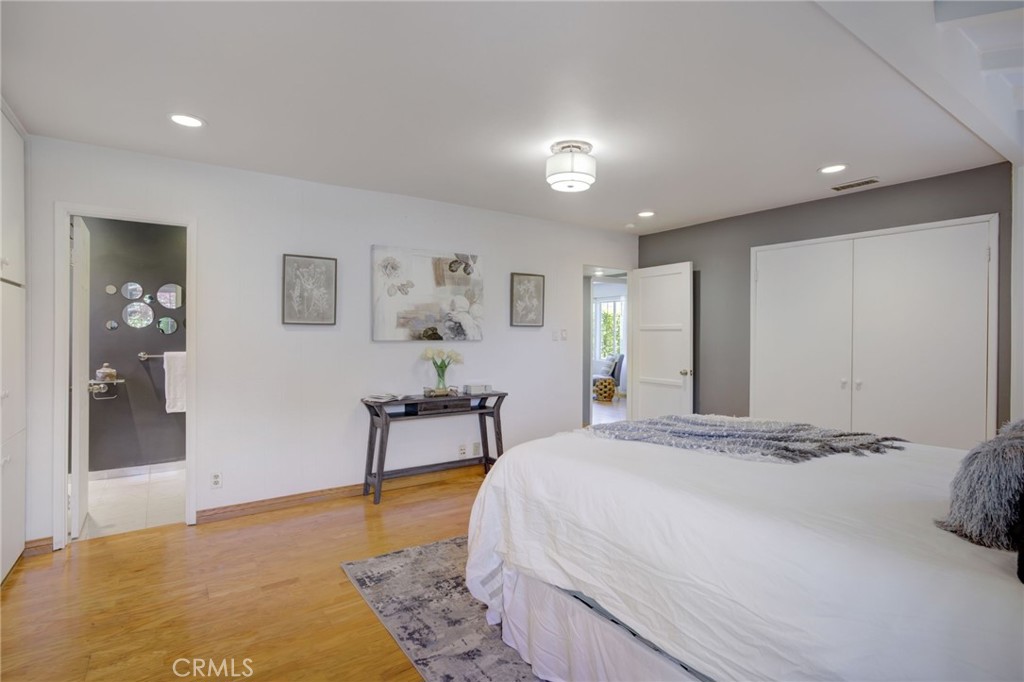 7001 Lindley Avenue Reseda, CA 91335 - Photo 21 of 45 a spacious bedroom with a bed and a table in it