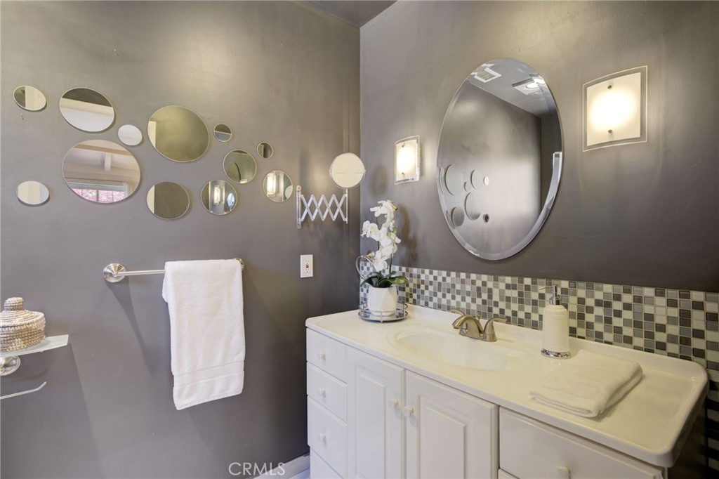7001 Lindley Avenue Reseda, CA 91335 - Photo 23 of 45 a bathroom with a sink mirror and vanity