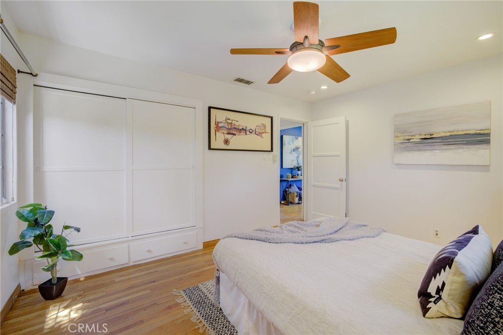 7001 Lindley Avenue Reseda, CA 91335 - Photo 25 of 45 a bedroom with a bed and a chandelier