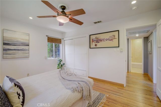 a bedroom with a bed and a painting on the wall