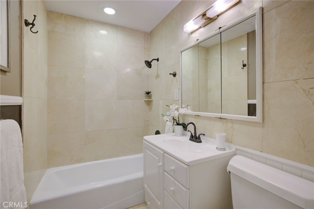 7001 Lindley Avenue Reseda, CA 91335 - Photo 28 of 45 a bathroom with a sink a toilet and shower