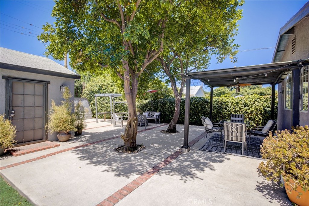 7001 Lindley Avenue Reseda, CA 91335 - Photo 29 of 45 a view of a patio with a table chairs and a backyard
