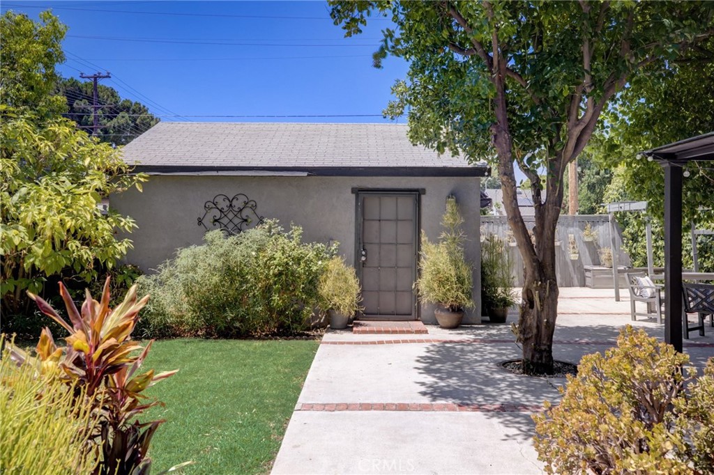 7001 Lindley Avenue Reseda, CA 91335 - Photo 31 of 45 a front view of a house with garden