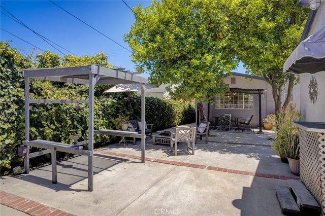 a view of a patio with a table and chairs under an umbrella