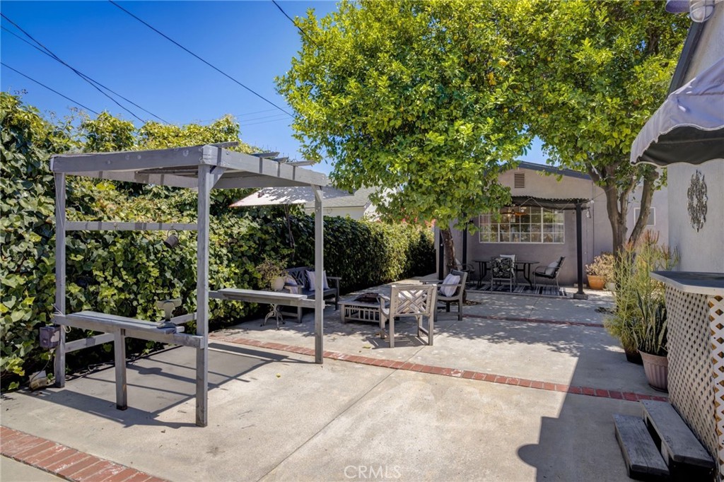7001 Lindley Avenue Reseda, CA 91335 - Photo 34 of 45 a view of a patio with a table and chairs under an umbrella