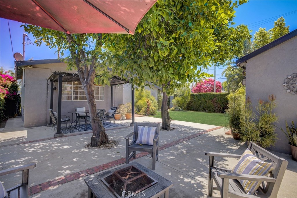7001 Lindley Avenue Reseda, CA 91335 - Photo 35 of 45 a view of a patio with table and chairs under an umbrella