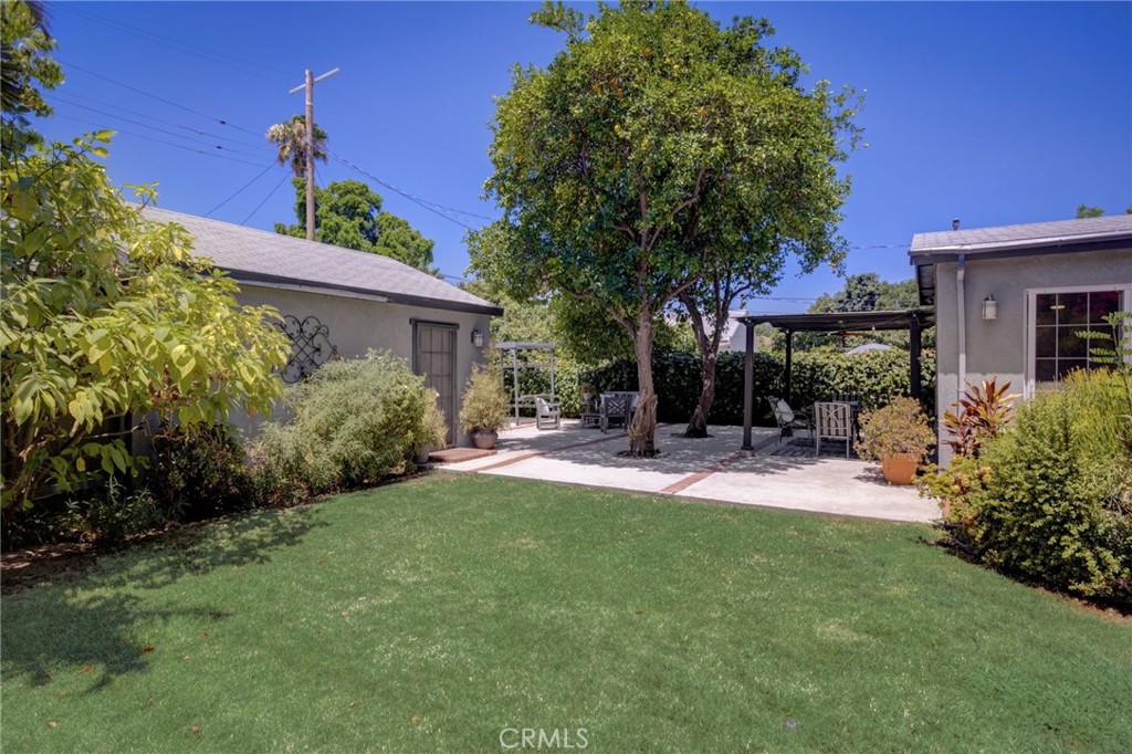 7001 Lindley Avenue Reseda, CA 91335 - Photo 37 of 45 a view of a patio with table and chairs potted plants and a large tree