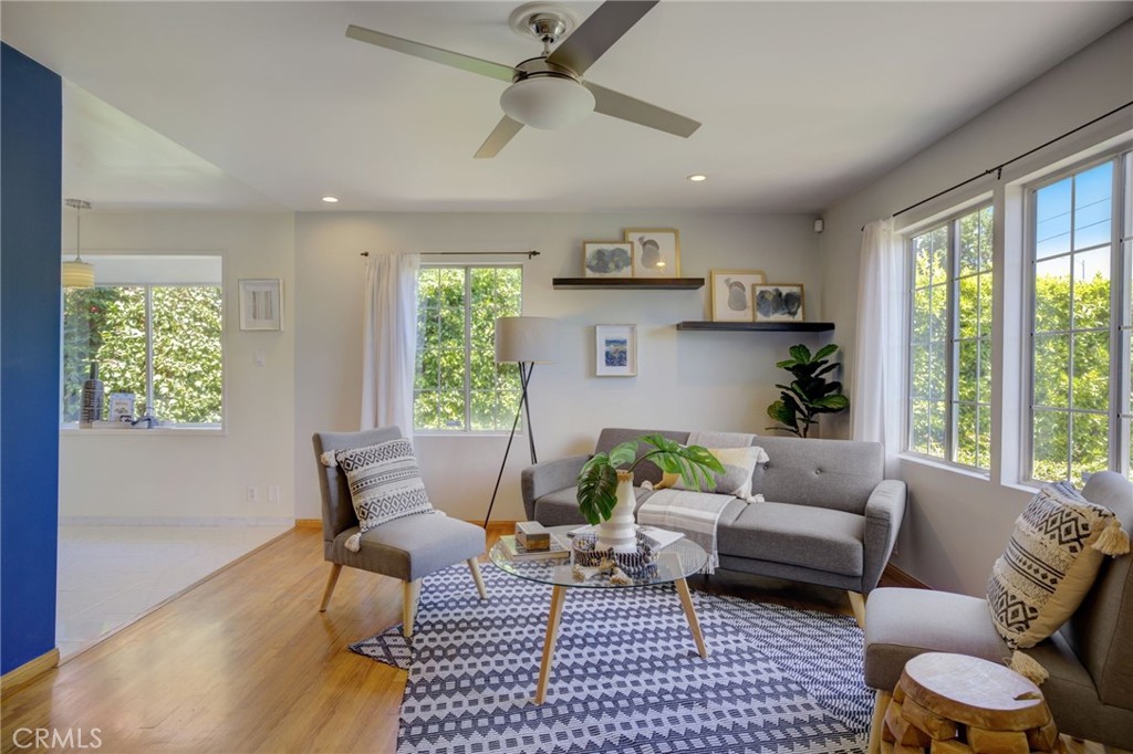 7001 Lindley Avenue Reseda, CA 91335 - Photo 5 of 45 a living room with furniture and a large window