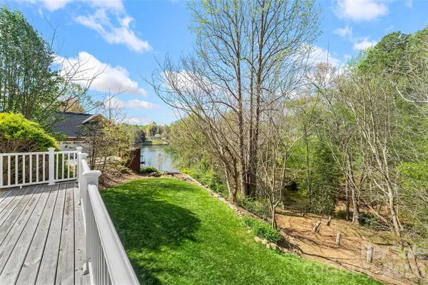 a view of a backyard with wooden fence