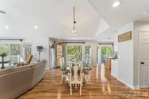 a dining room with furniture a chandelier and wooden floor