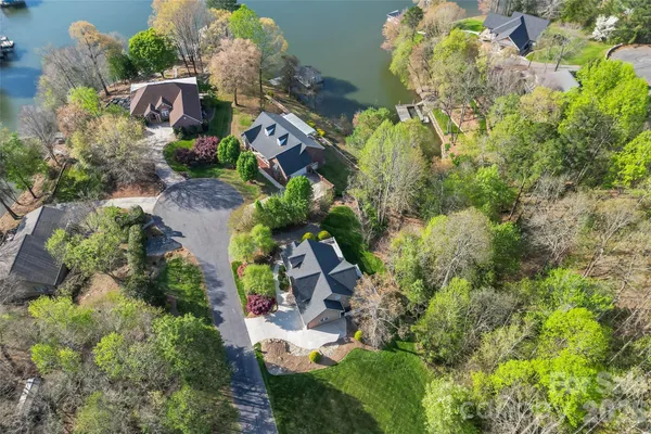 an aerial view of a house with a yard and covered with swimming pool