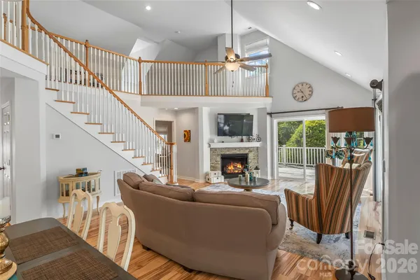 a living room with furniture fireplace and a large window