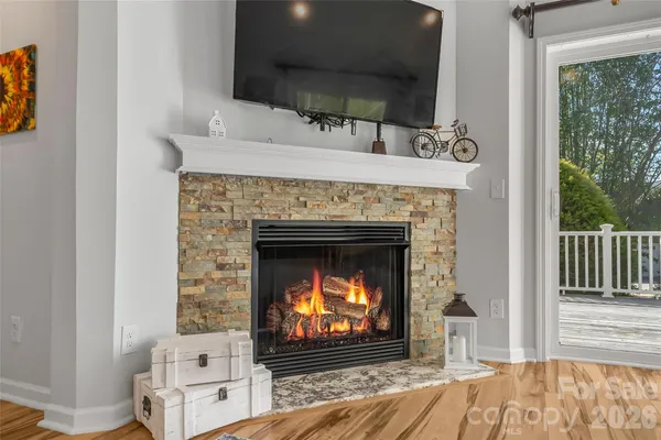 a living room with a fireplace a flat screen tv and a fireplace