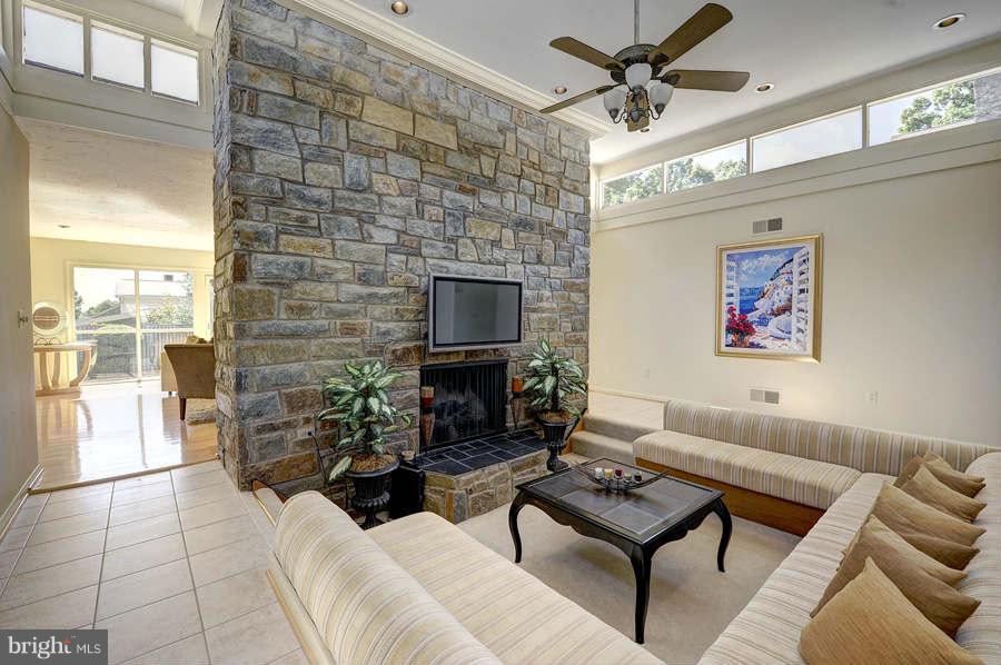 10009 Hall Road Potomac, MD 20854 - Photo 3 of 10 a living room with furniture a flat screen tv and a fireplace