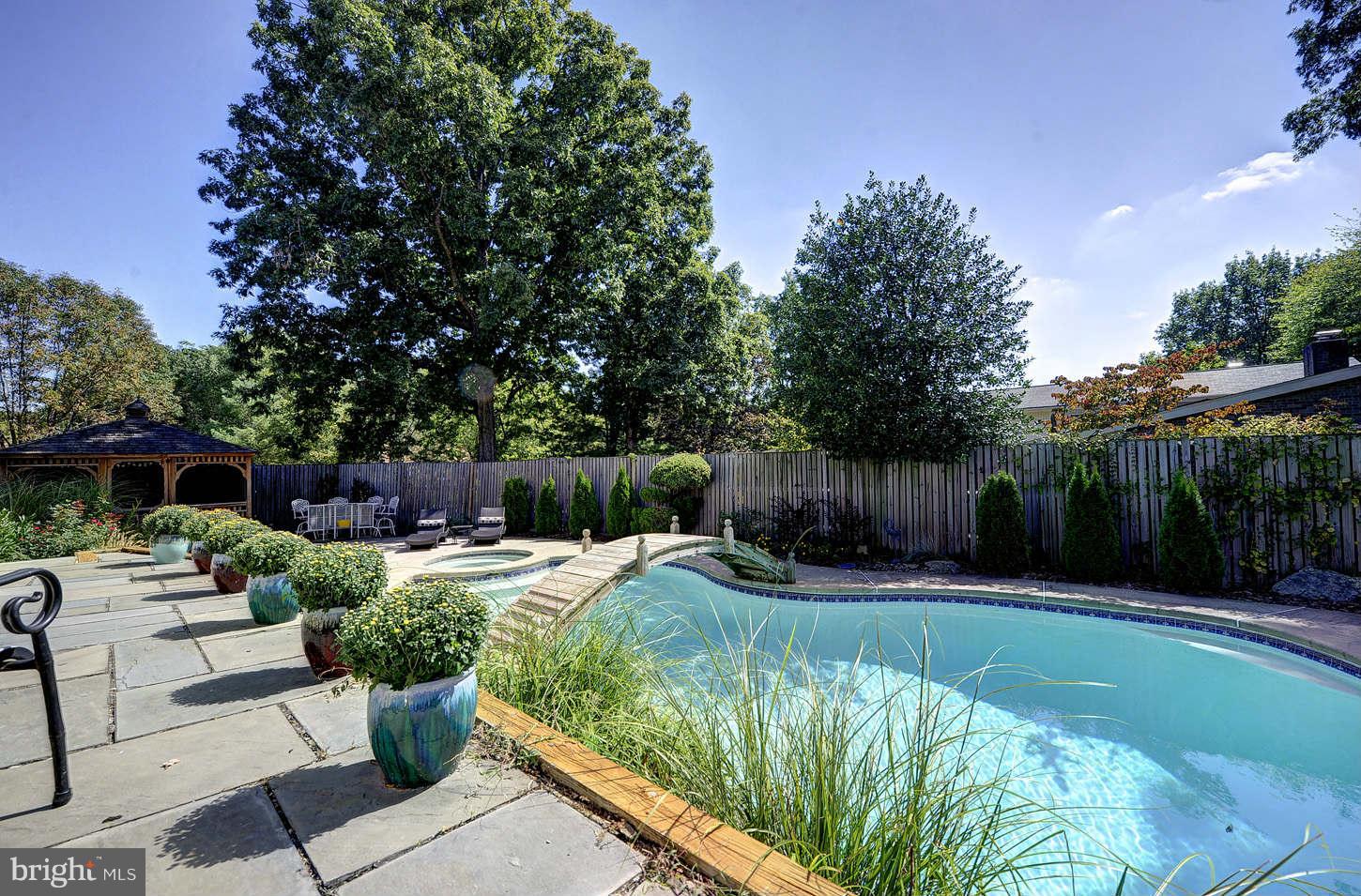 10009 Hall Road Potomac, MD 20854 - Photo 10 of 10 a view of backyard with seating space and trees
