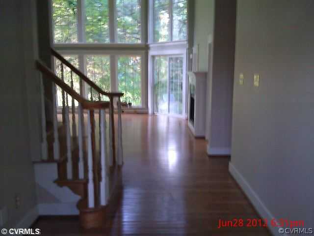 4212 Whitehall Road Sandy Hook, VA 23153 - Photo 2 of 9 a view of a hallway with wooden floor and stairs