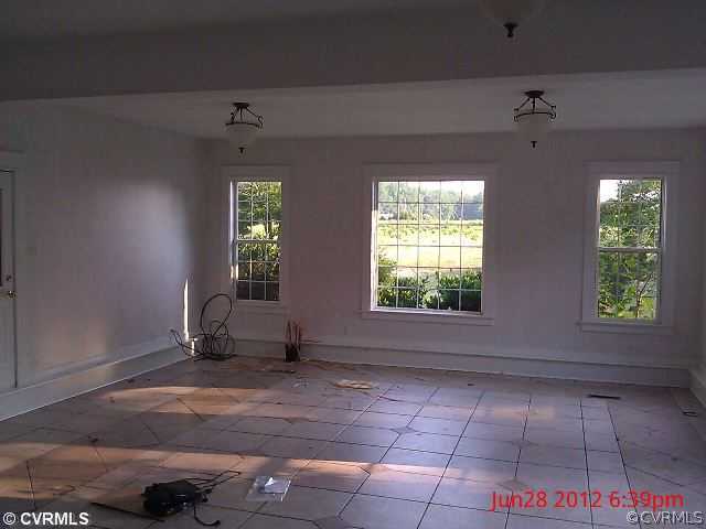 4212 Whitehall Road Sandy Hook, VA 23153 - Photo 7 of 9 an empty room with windows