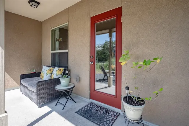 a dining room with furniture and a potted plant