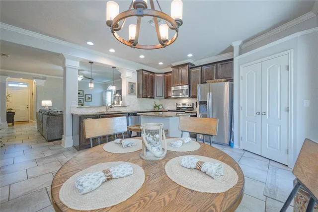 a kitchen with a dining table and chairs