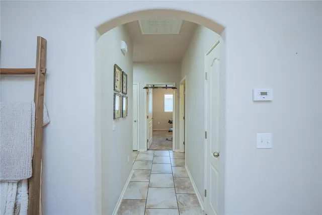 a view of a hallway with a cabinet and a mirror