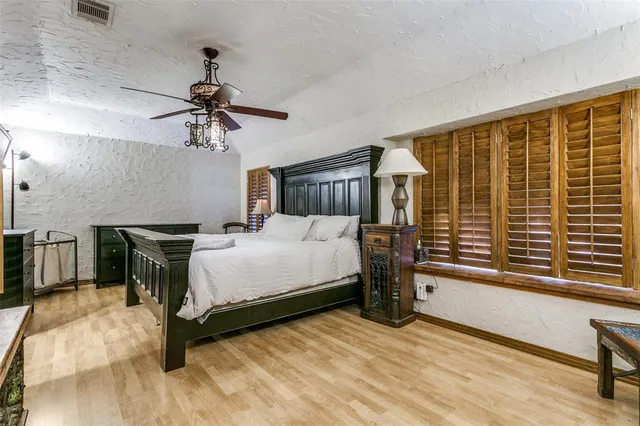 a bed room with a bed and a chandelier