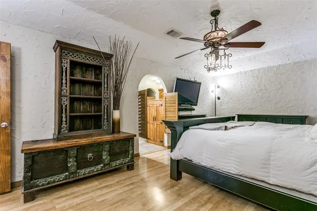 a bedroom with a bed and a chandelier