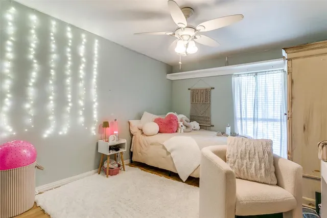 a bedroom with a bed and chandelier