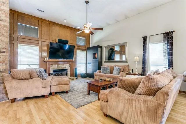 a living room with furniture a fireplace and a flat screen tv