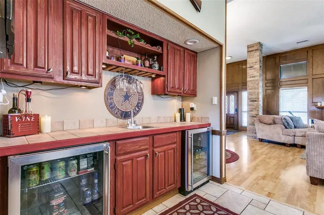 a view of a kitchen with stainless steel appliances granite countertop a stove a sink and dishwasher
