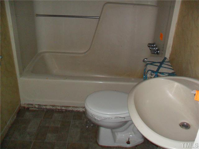 2402 Redwood Road Durham, NC 27704 - Photo 7 of 10 a bathroom with a toilet and a tub
