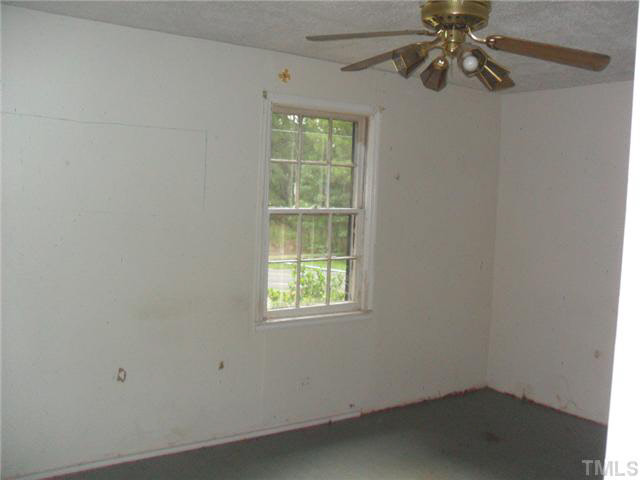 2402 Redwood Road Durham, NC 27704 - Photo 8 of 10 an empty room with a window and a fan