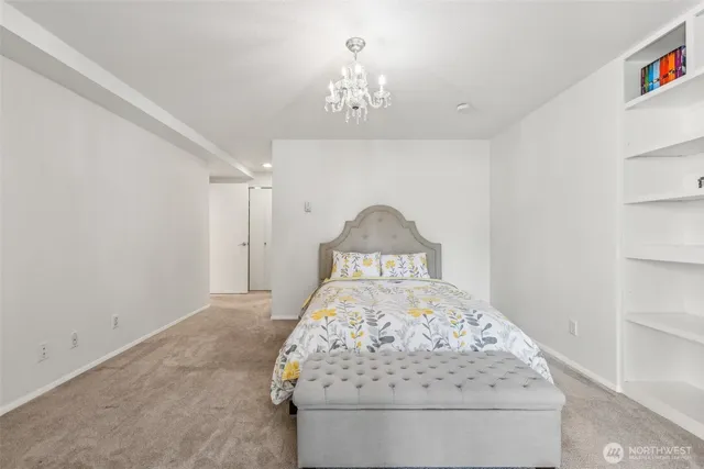 a bedroom with a bed and a chandelier