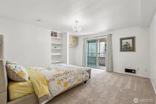 a bedroom with a large bed and a chandelier