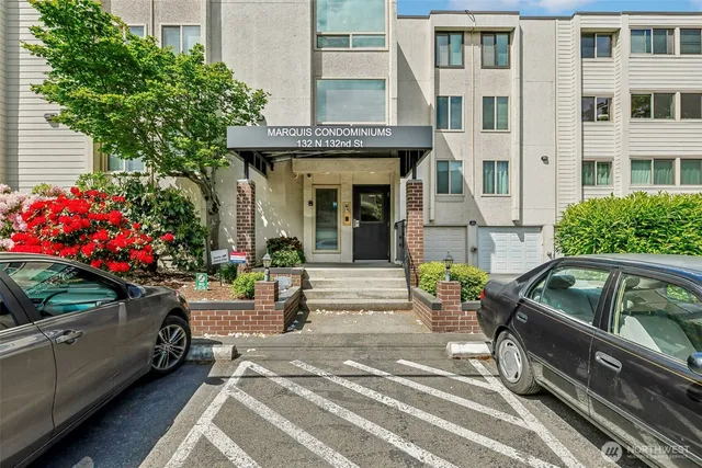 a view of a two chairs and a cars park on the road