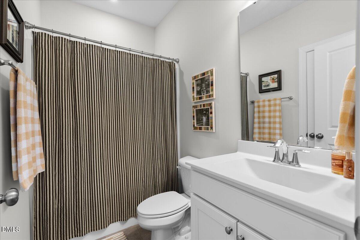 100 Masden Road Holly Springs, NC 27540 - Photo 13 of 39 a bathroom with a sink toilet and shower