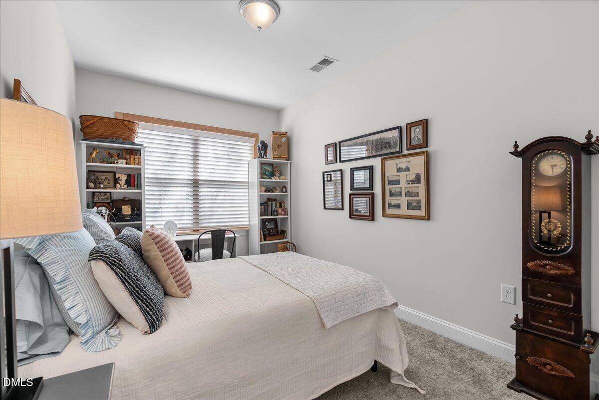 100 Masden Road Holly Springs, NC 27540 - Photo 14 of 39 a bedroom with a bed and a window