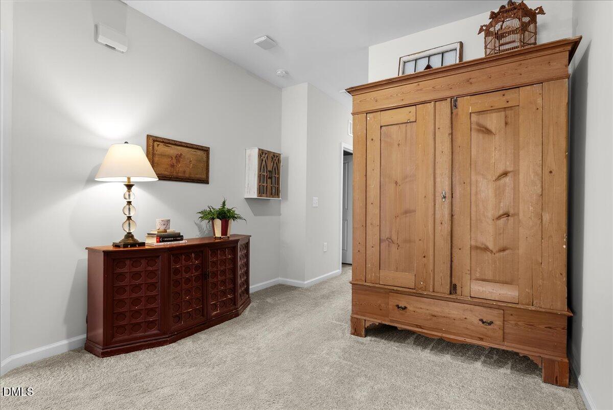 100 Masden Road Holly Springs, NC 27540 - Photo 17 of 39 a living room with furniture and a flat screen tv
