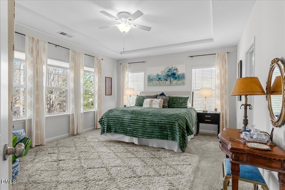 100 Masden Road Holly Springs, NC 27540 - Photo 19 of 39 a bedroom with a large bed and a chandelier