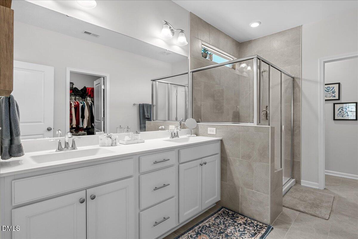 100 Masden Road Holly Springs, NC 27540 - Photo 20 of 39 a bathroom with double sink and a mirror