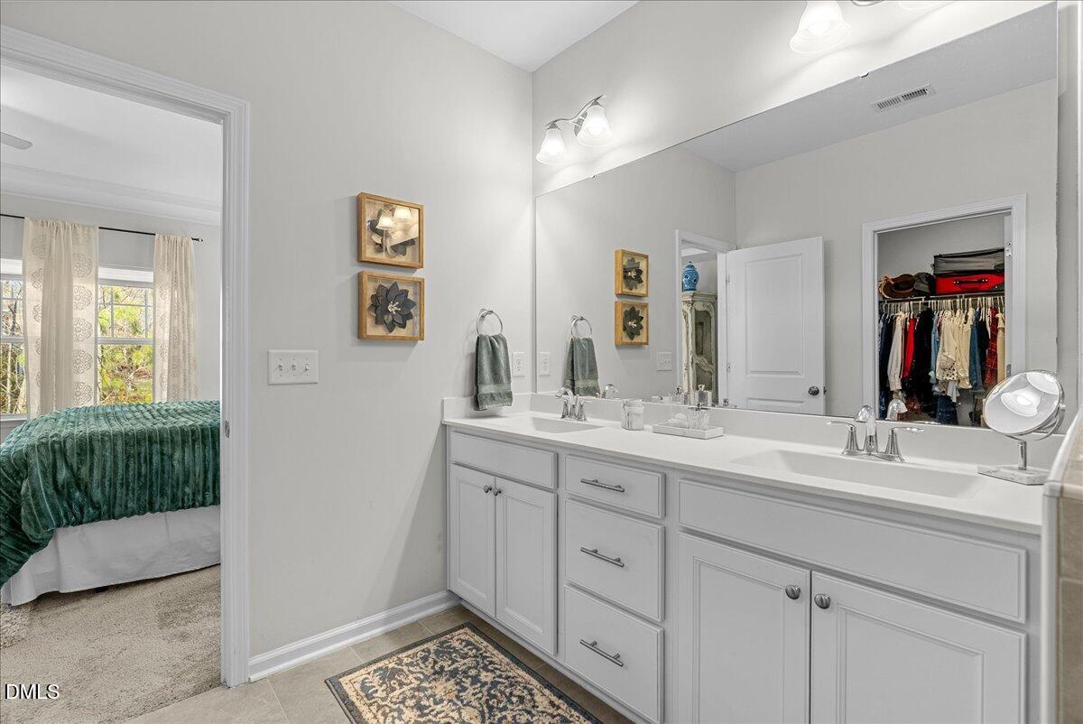 100 Masden Road Holly Springs, NC 27540 - Photo 21 of 39 a bathroom with a sink and a mirror