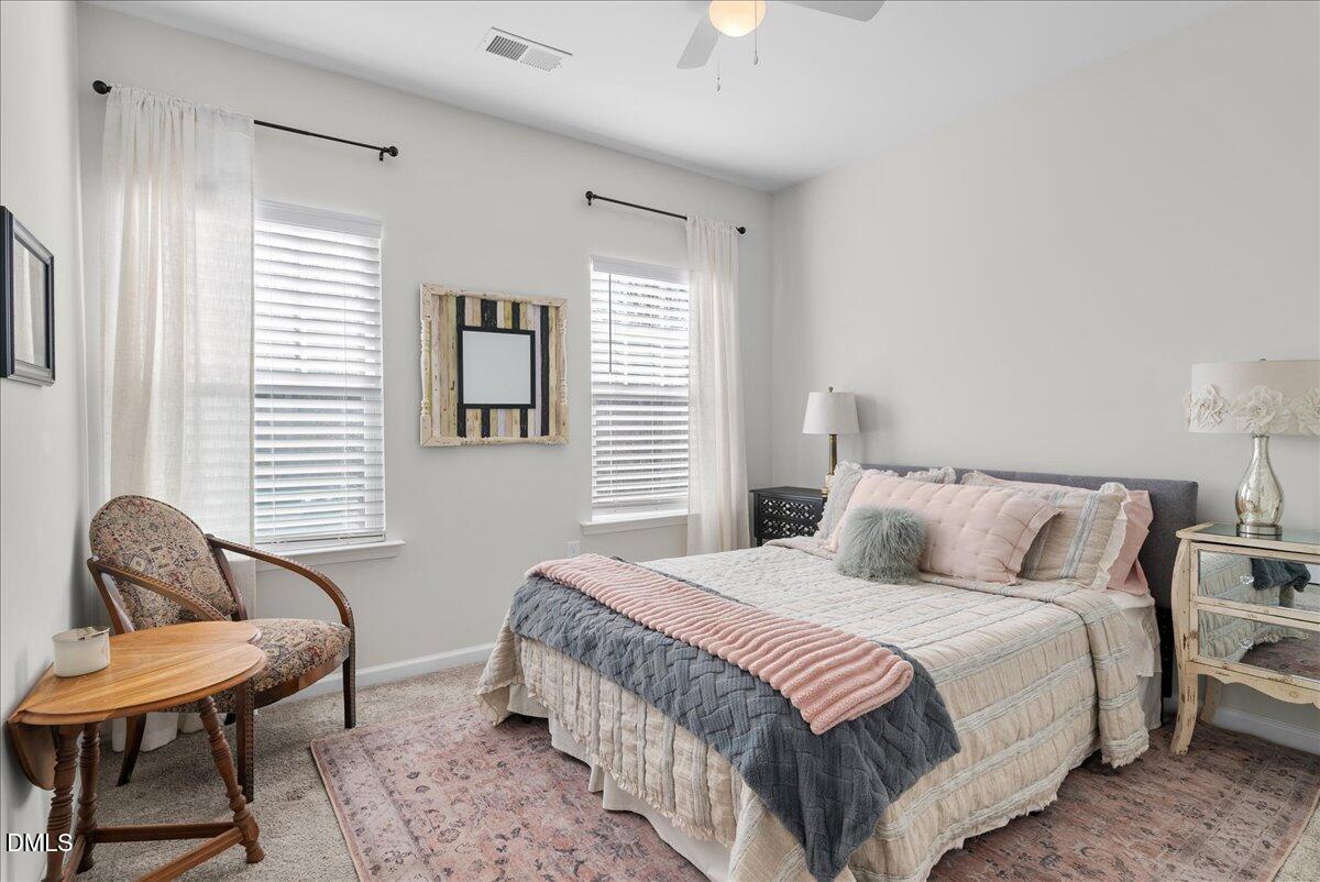 100 Masden Road Holly Springs, NC 27540 - Photo 22 of 39 a bedroom with a bed chair and a window