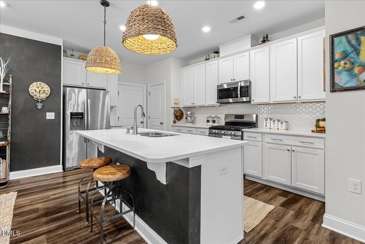 100 Masden Road Holly Springs, NC 27540 - Photo 5 of 39 a kitchen with a sink cabinets and window