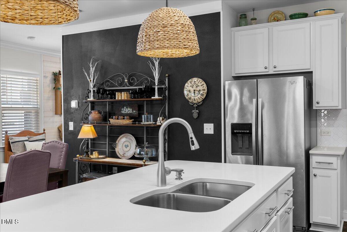 100 Masden Road Holly Springs, NC 27540 - Photo 6 of 39 a kitchen with a sink and a stove
