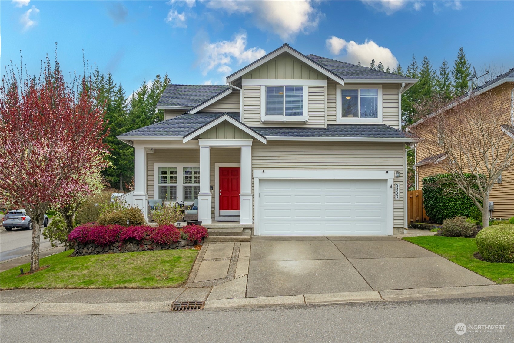 28002 Maple Ridge Way Southeast Maple Valley, WA 98038 - Photo 1 of 33 a front view of a house with a yard and garage